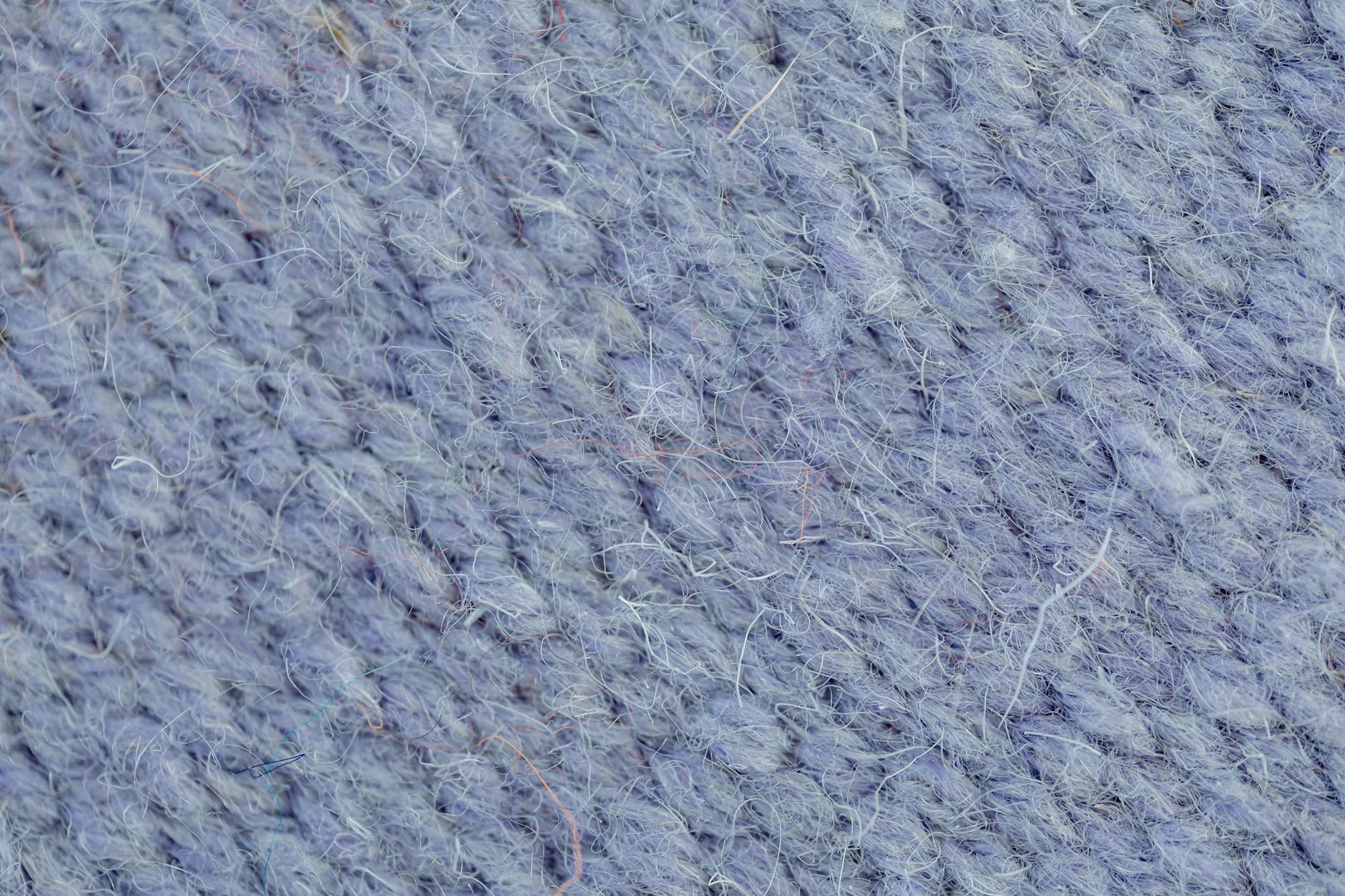 Zbliżenie na fakturę niebieskiej wełnianej dzianiny